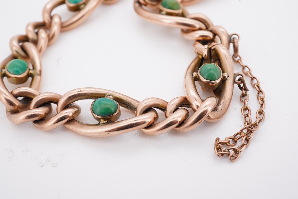 An early 20th century yellow metal (stamped 9c) and seven stone cabochon turquoise set curb link bracelet, 19cm, gross weight 14 grams. Condition - poor to fair
